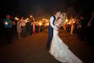 bride and groom sparkler exit, form fitting gown with textured train