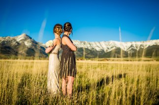 bride and maid of honor in a field