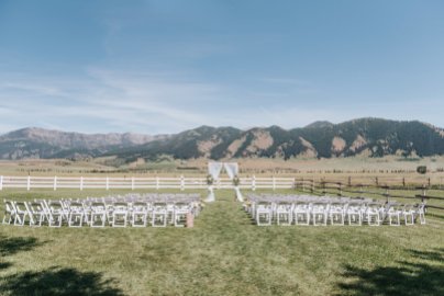 wedding ceremony with arch, fabric draping and floral, mountain views